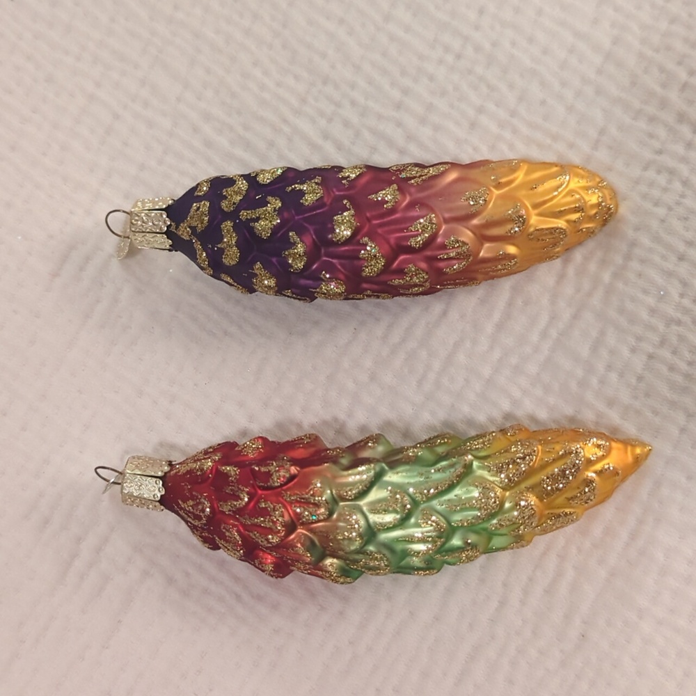 Set of 2 multicolored Old World Christmas pinecone ornaments.